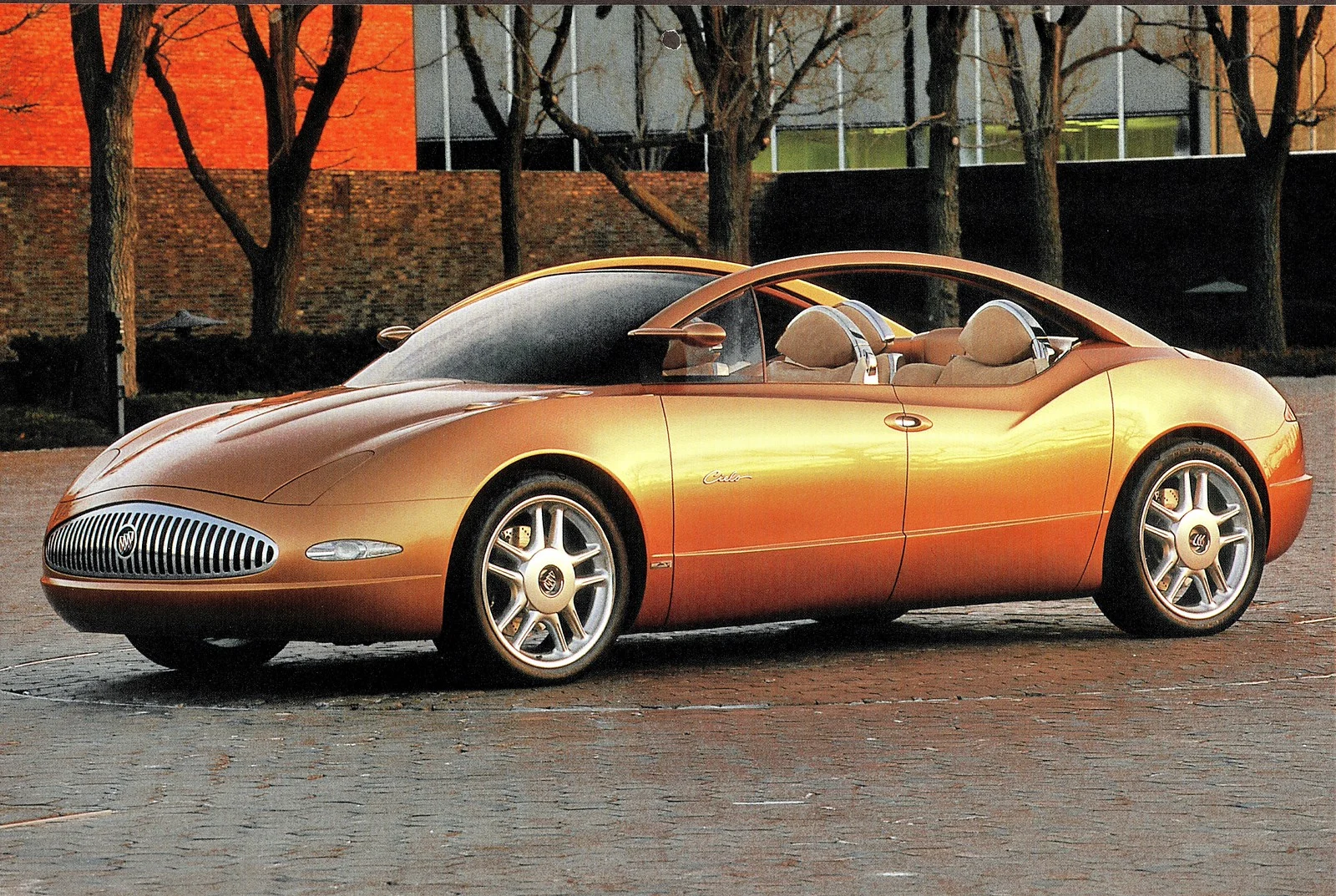 Orange 1999 Buick Cielo four-door open-roof concept photographed outdoors